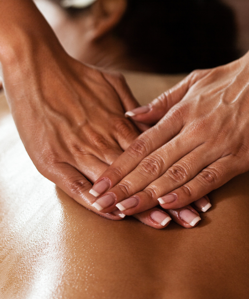 A woman getting a back massage at a spa