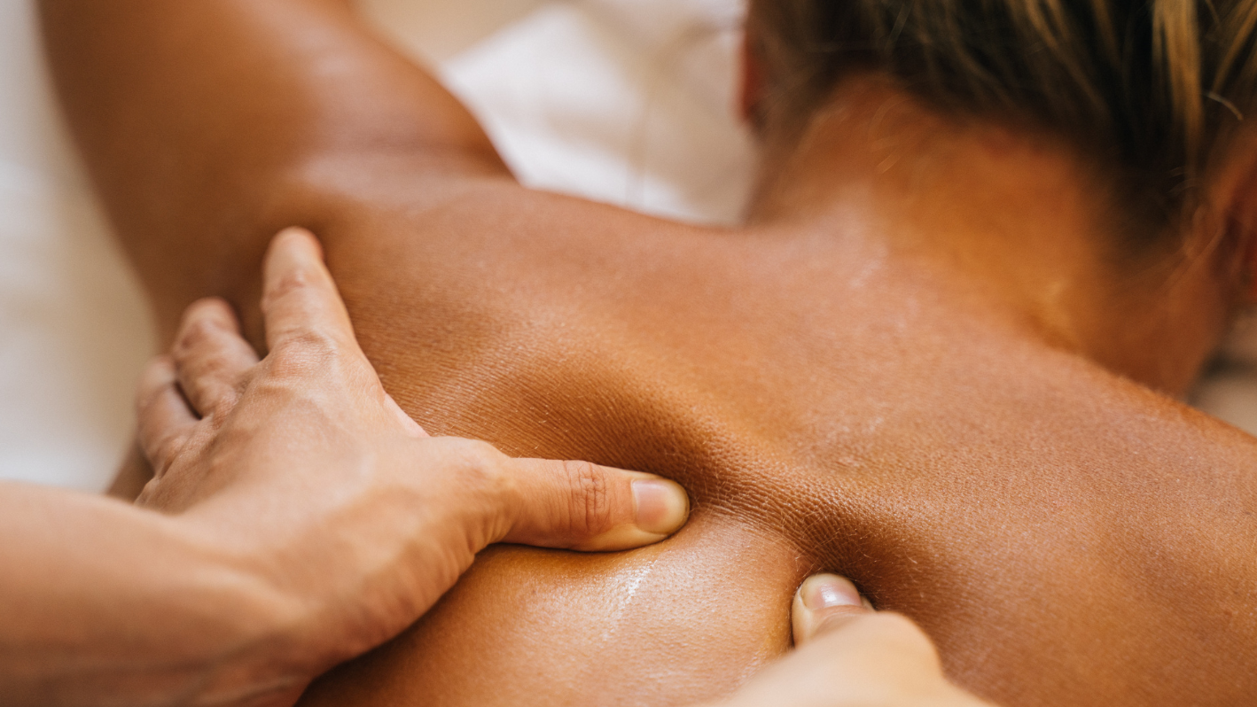 A woman getting a back massage at a spa